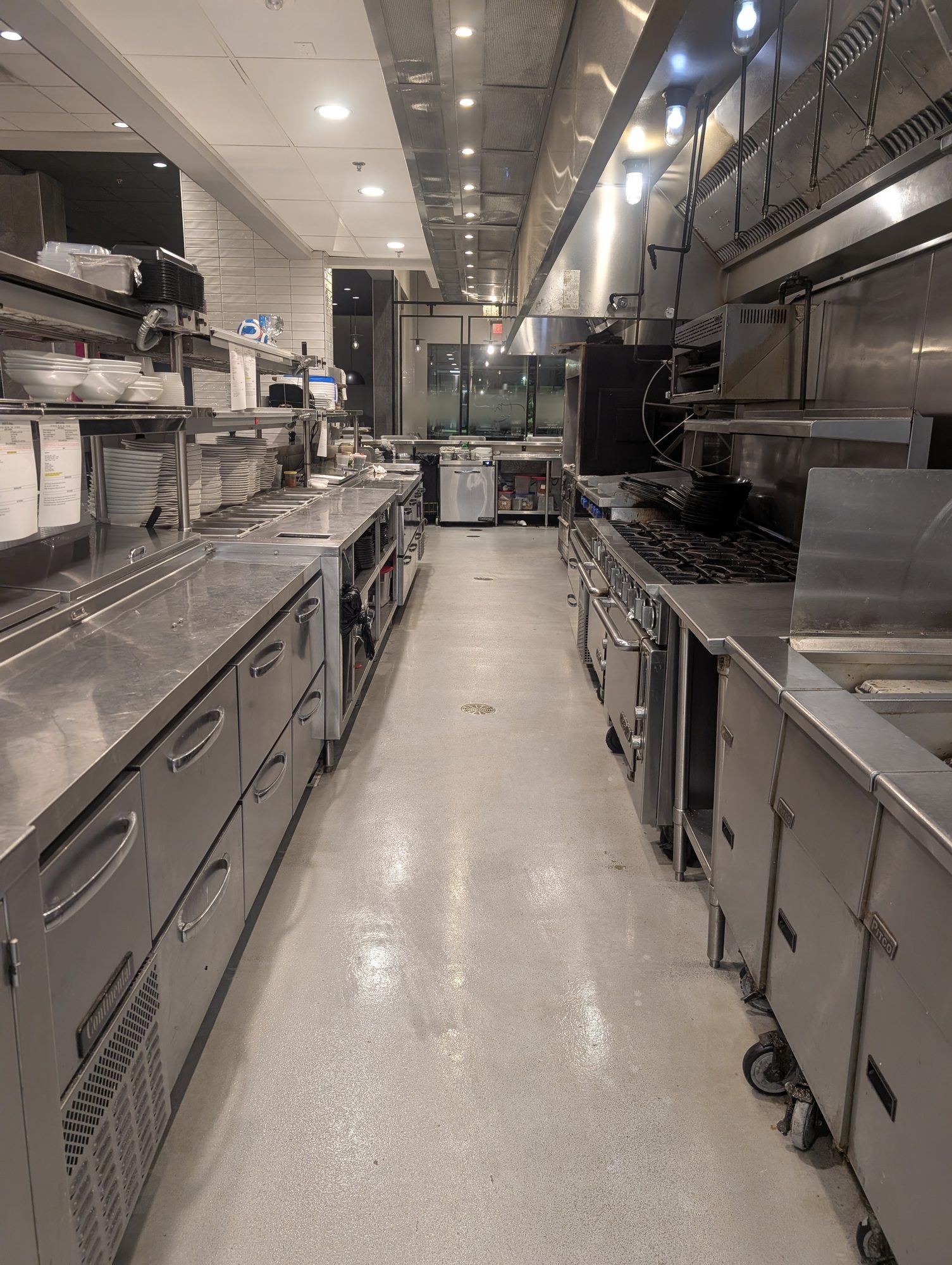 Clean commercial kitchen aisle after exhaust system service