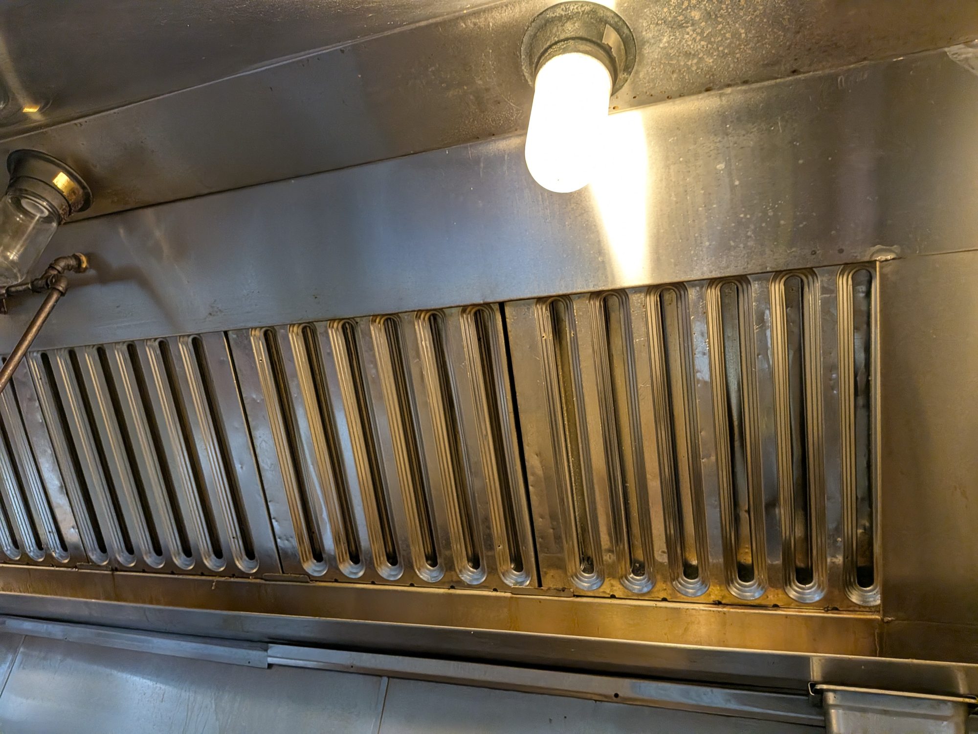 Cleaned baffle filter bank in a commercial kitchen hood