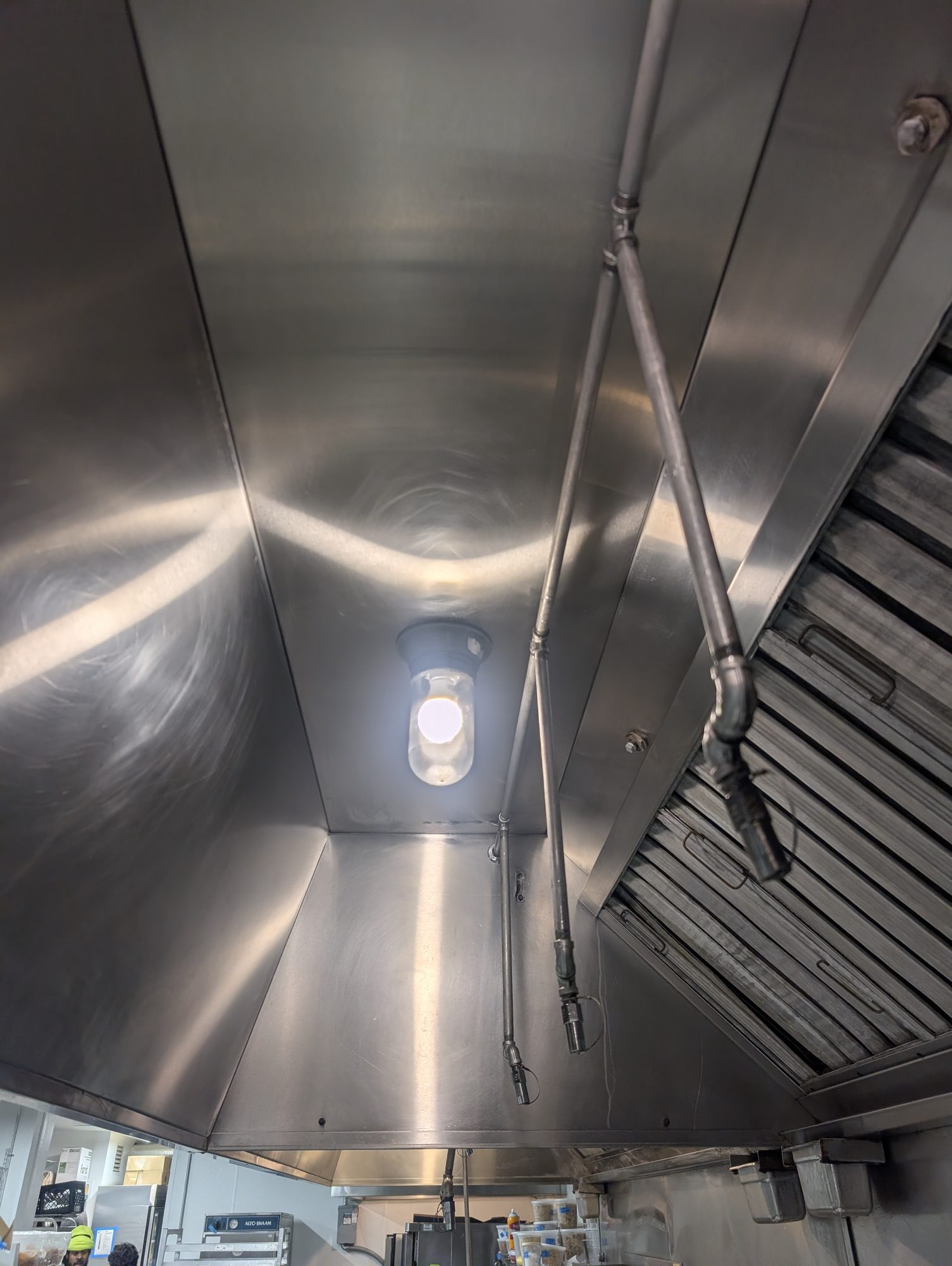 Inside a commercial kitchen hood plenum cleaned to bare metal