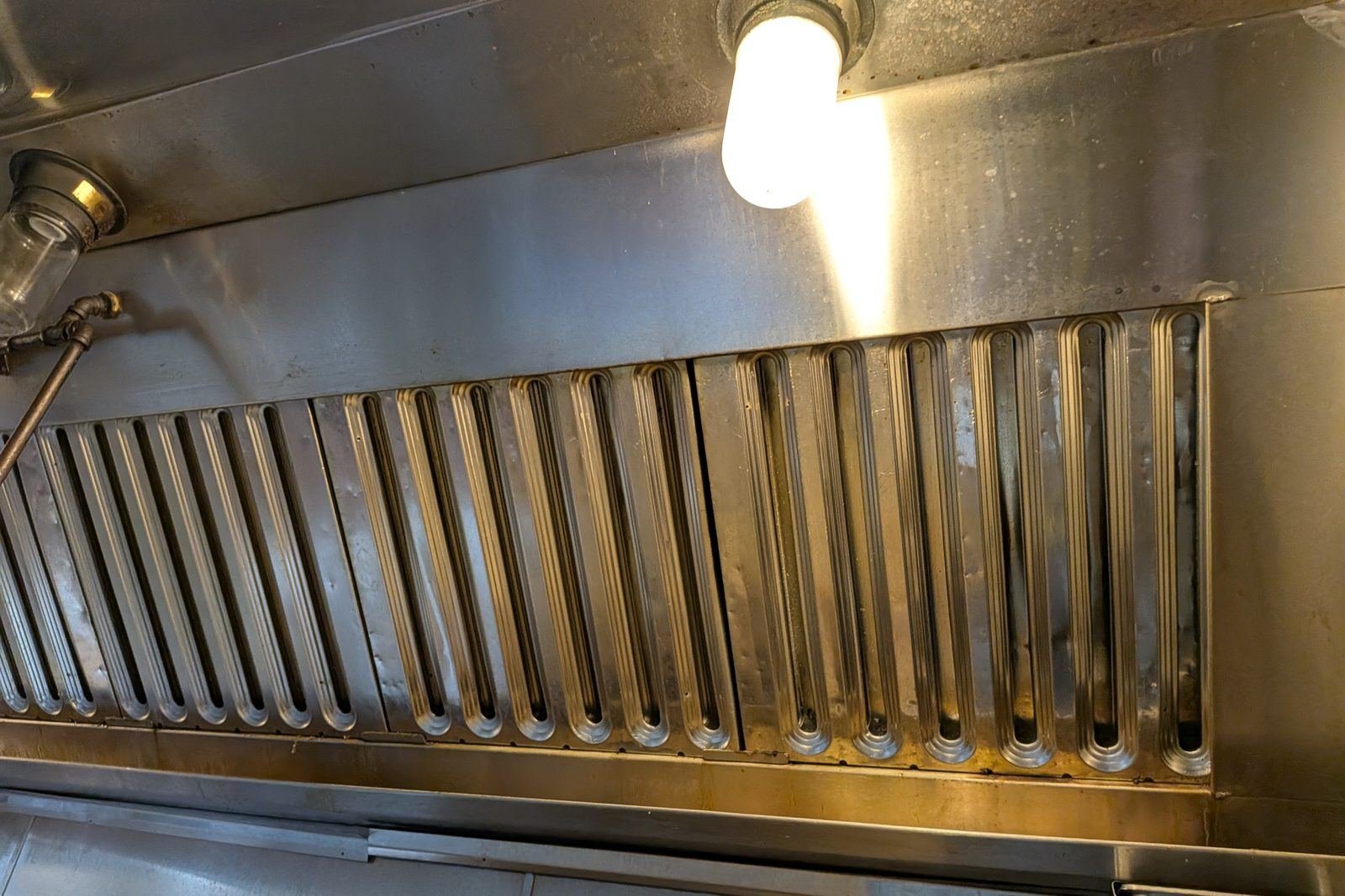 Clean baffle filters installed in a commercial kitchen hood