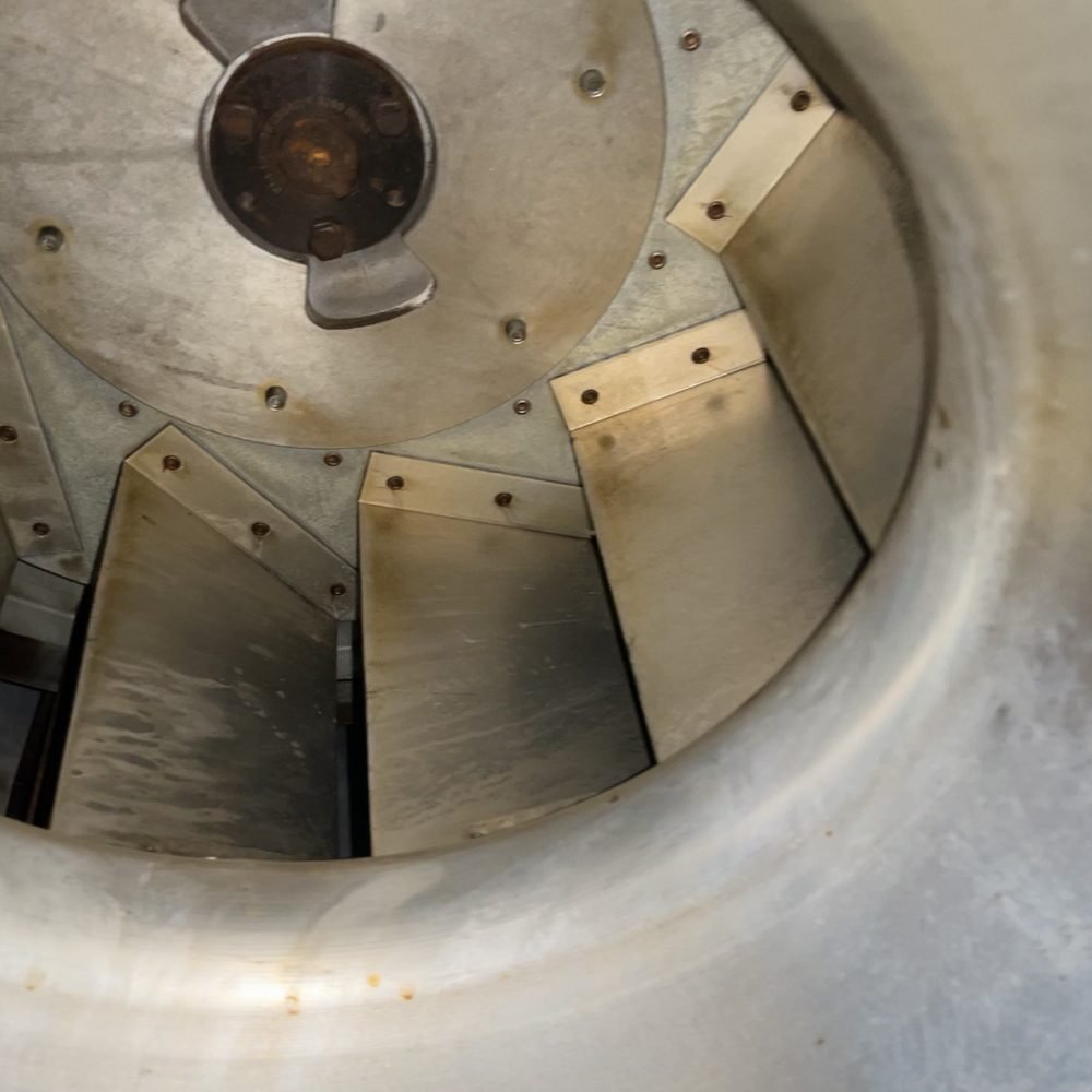 Rooftop exhaust fan wheel cleaned down to bare metal